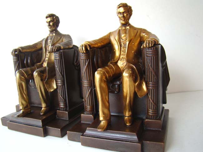 An assembled pair of antique "Lincoln in the chair" bookends by Jennings Brothers circa 1930